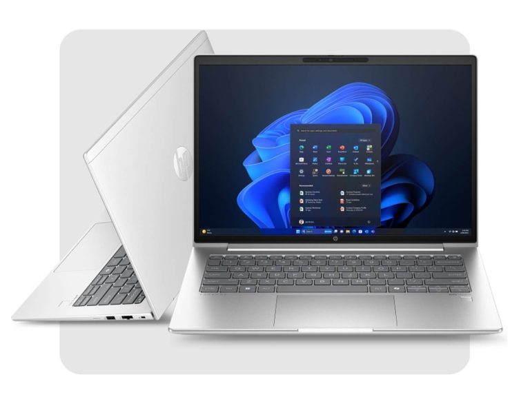 Silver HP laptop open with Windows 11 start menu and another laptop showing its back logo behind it.
